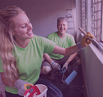 Rotary volunteers painting a room