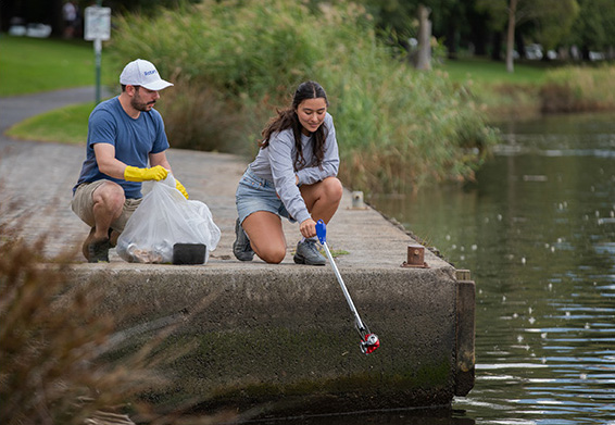 Rotary volunteers cleaning up a pond in the community